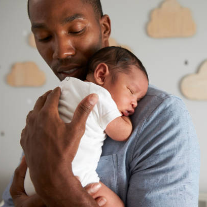 Man holding his newborn baby peacefully