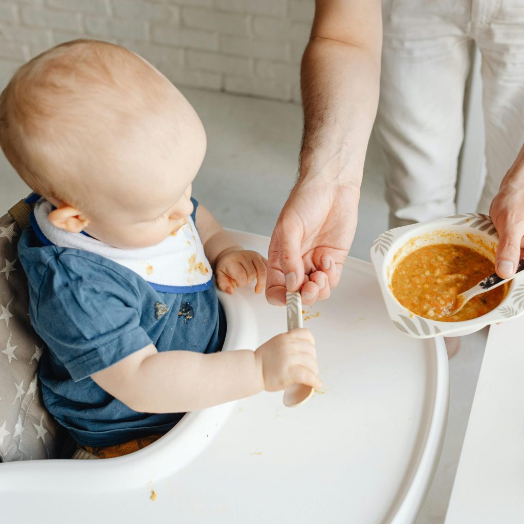 When and How Do I Introduce Solid Food to My Baby? Baby eating puree